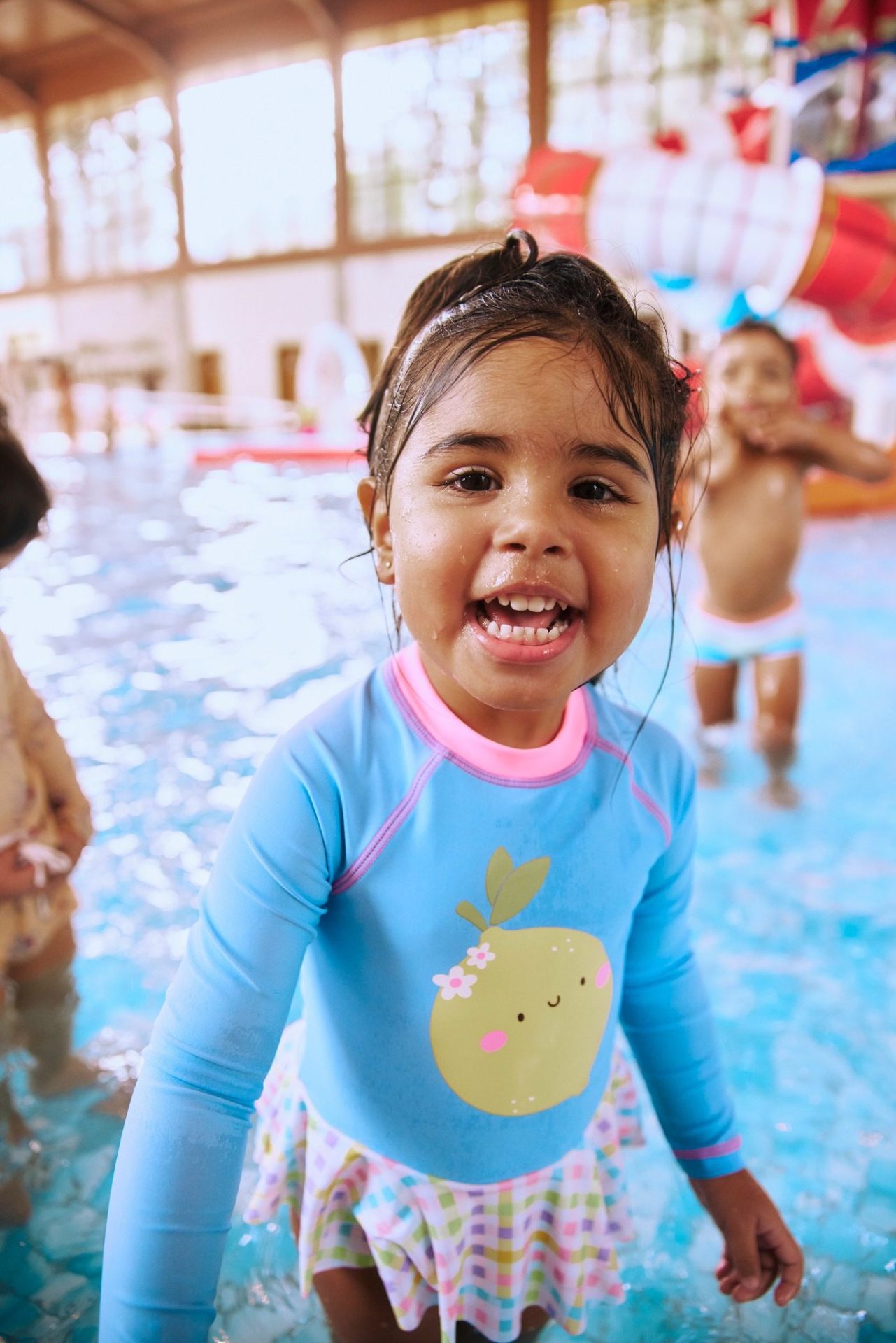 Criança sorrindo na piscina infantil do Parque Aquático Alpenmare